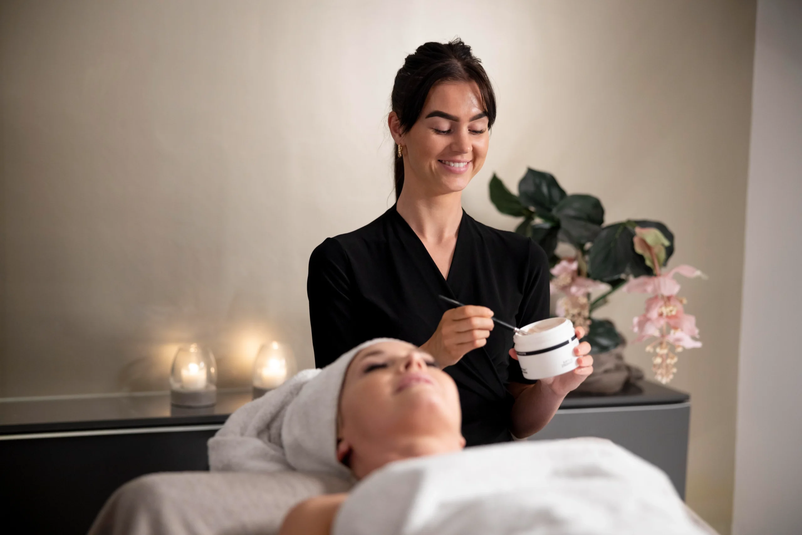 young-woman-using-face-treatment-her-client young-woman-using-face-treatment-her-client